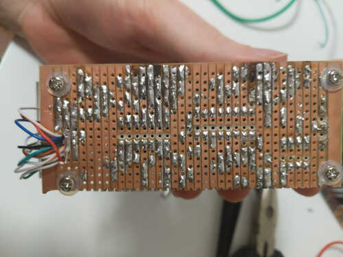 The underside of the circuit board showing copper strips with solder