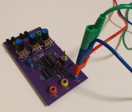 An analog synthesizer module with a stack of multiple cable terminators plugged into the same jack socket.